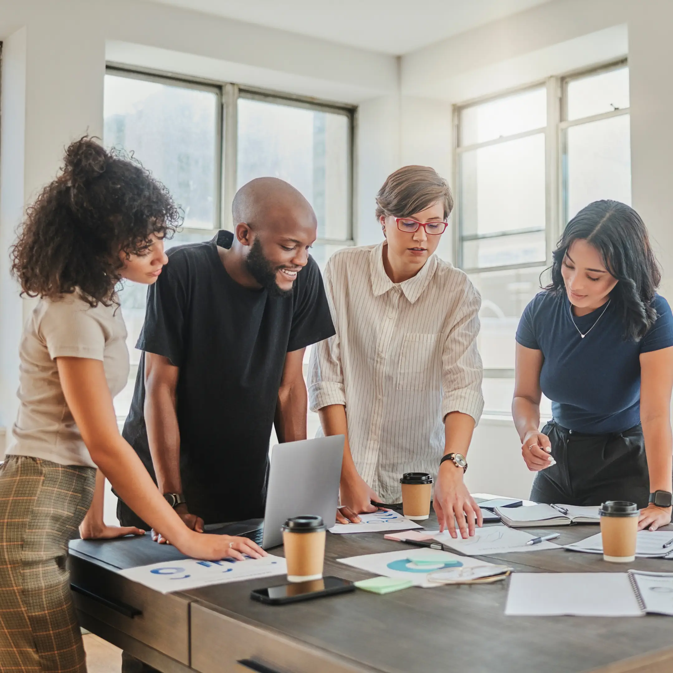 Team collaborating on project around a table.